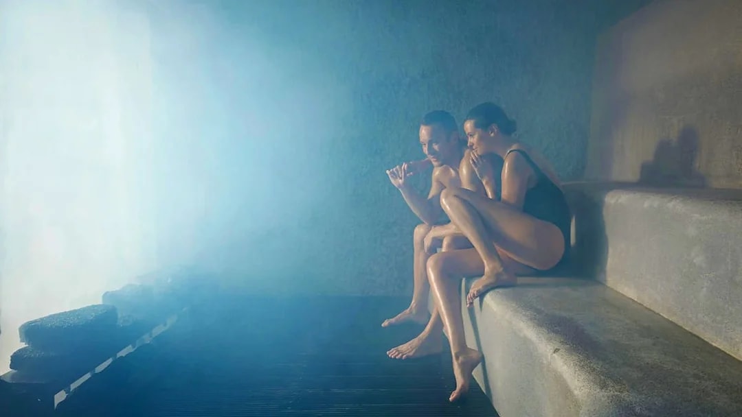 Two people relaxing in a steam room at Blue Lagoon, Iceland.