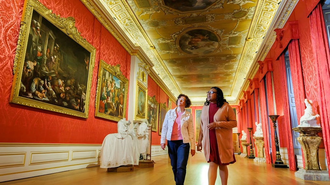 Visitors exploring art gallery at Kensington Palace, London.