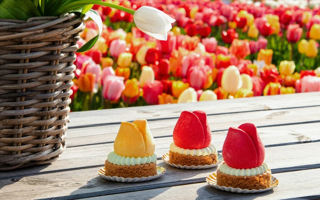 Tulip-shaped pastries on a wooden table at Tulip Experience Amsterdam.