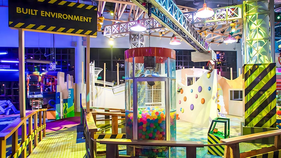 Interactive play area at KidsSTOP Singapore with colorful structures and ball pit.