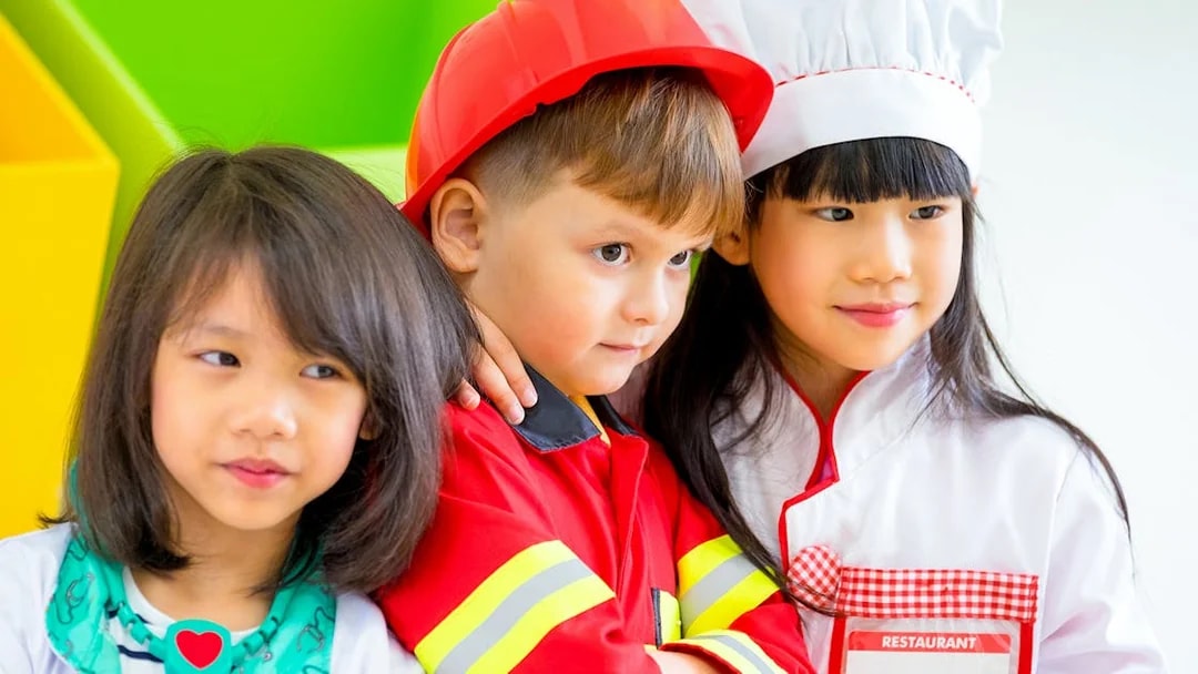 Children in costumes at KidsSTOP Singapore interactive exhibit.