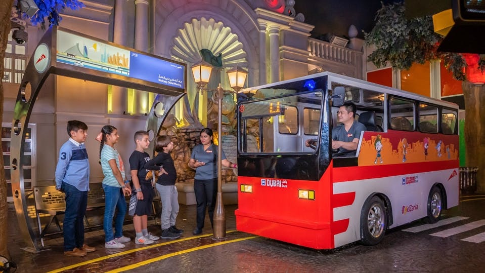 Children boarding a mini bus at KidZania Dubai.