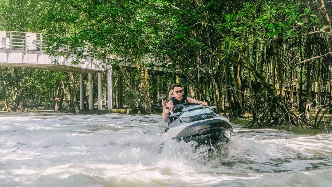 Jet ski navigating through mangroves in Langkawi's UNESCO Kilim Geopark.