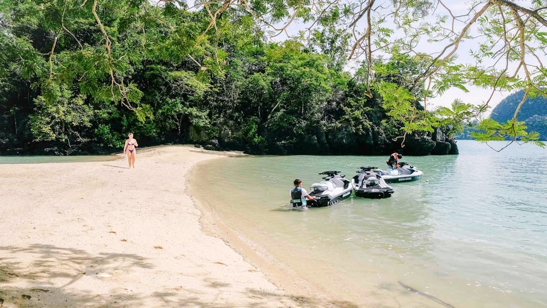 Jet skis on a sandy beach in Langkawi's UNESCO Kilim Geopark.