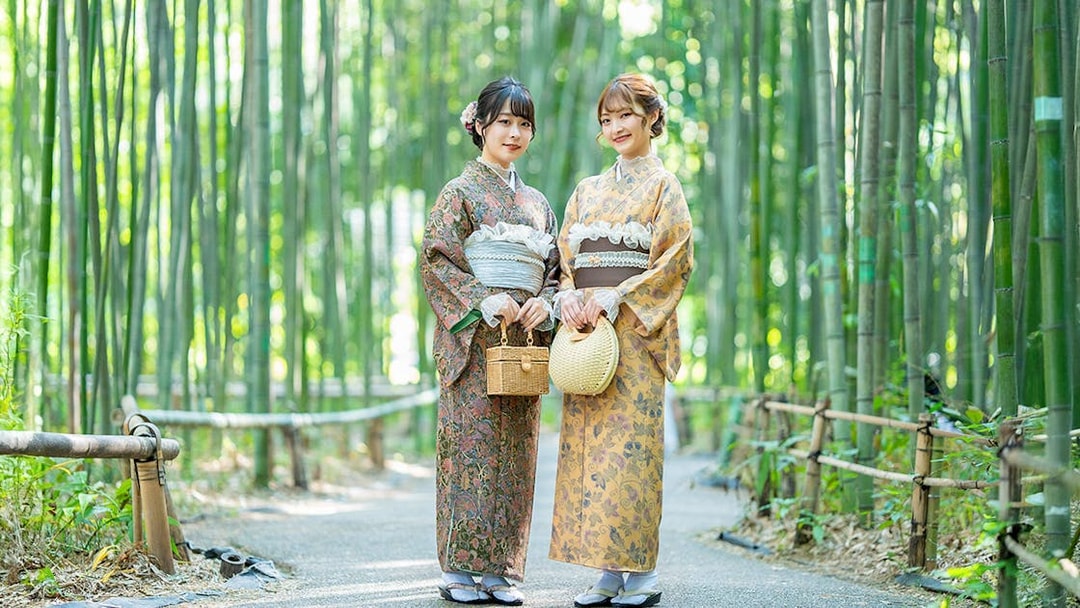 Visitors wearing kimonos in Kyoto's Arashiyama bamboo grove.