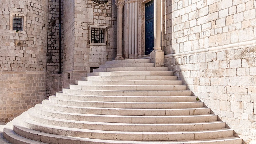 Stone steps leading to a historic building in Dubrovnik, featured in King's Landing Walking Tour.