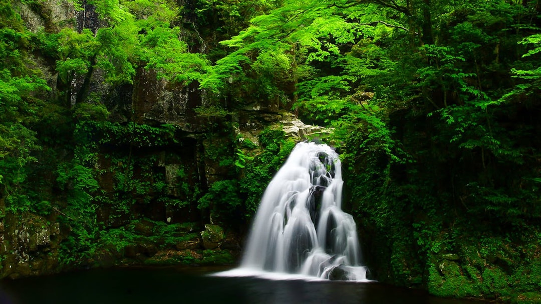 Waterfall surrounded by lush greenery in Mie Prefecture, accessible with Kintetsu Rail Pass.