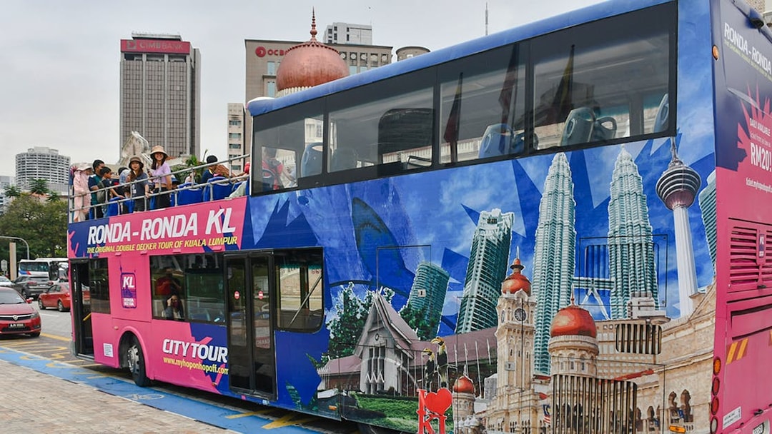 Passengers on a double-decker bus during the Kuala Lumpur Hop-On Hop-Off Tour.