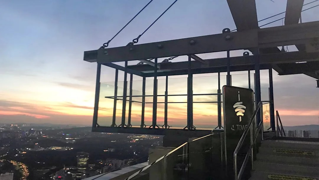 KL Tower SkyBox overlooking Kuala Lumpur cityscape at sunset.