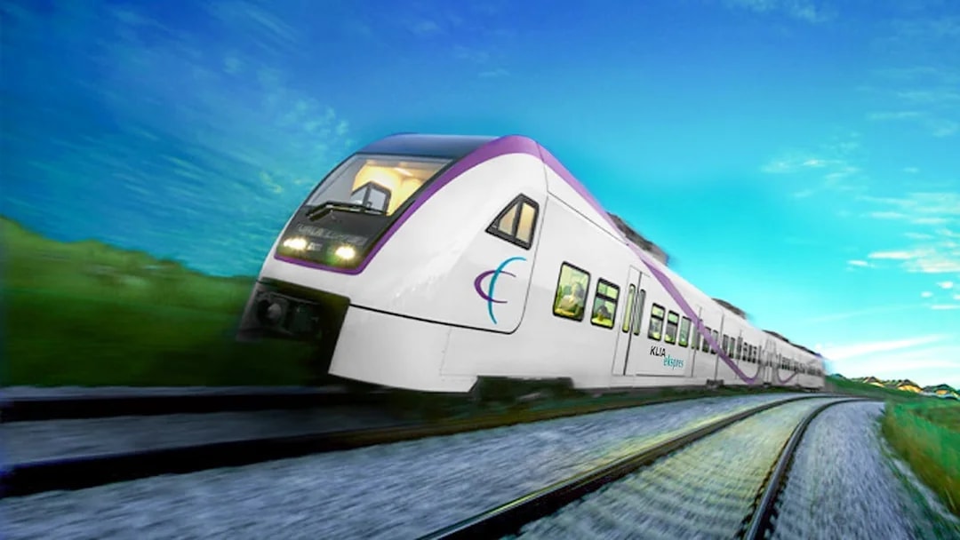 KLIA Ekspres train traveling on tracks under a clear blue sky.