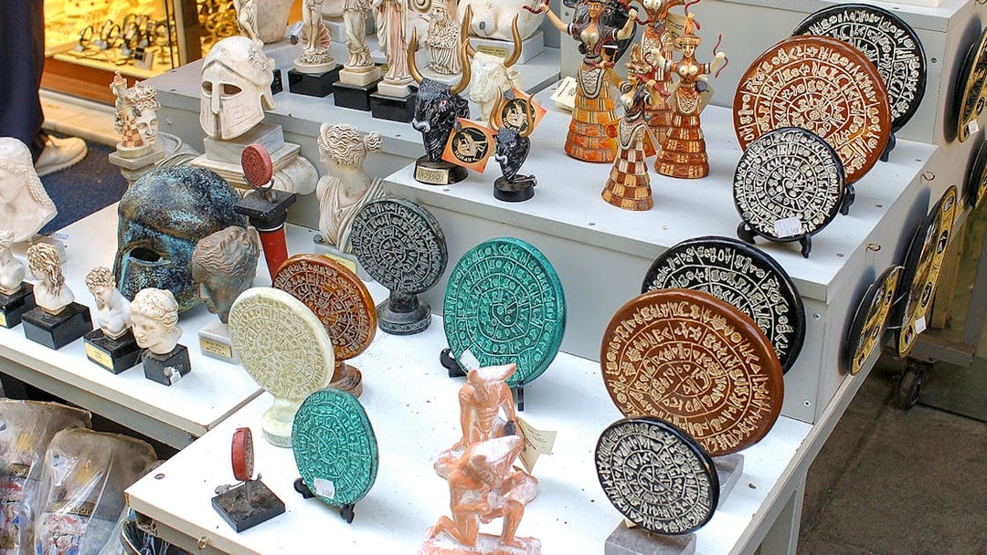 Souvenirs depicting ancient Greek artifacts at Knossos Palace site.