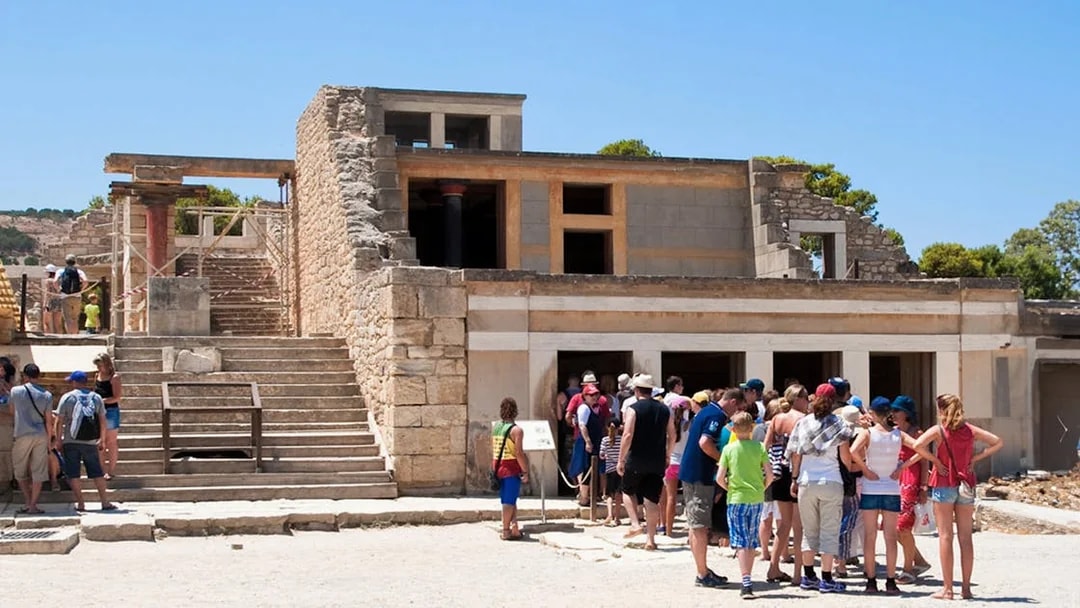 Visitors exploring the ruins of Knossos Palace in Crete.