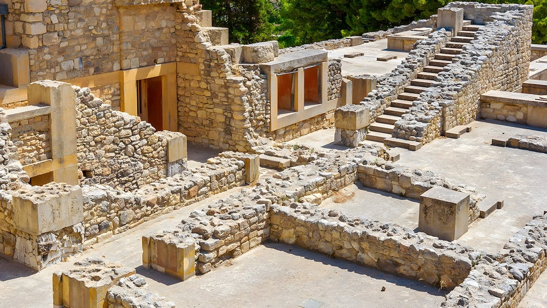 Knossos Palace ruins with stone rooms and stairs in Crete, Greece.