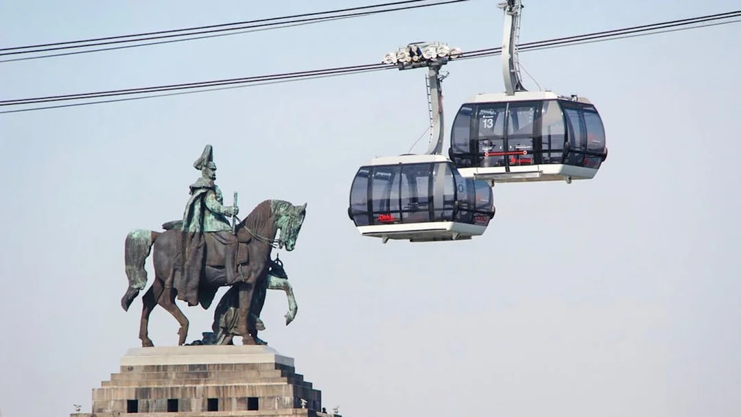 Koblenz Cable Car passing equestrian statue in Germany.