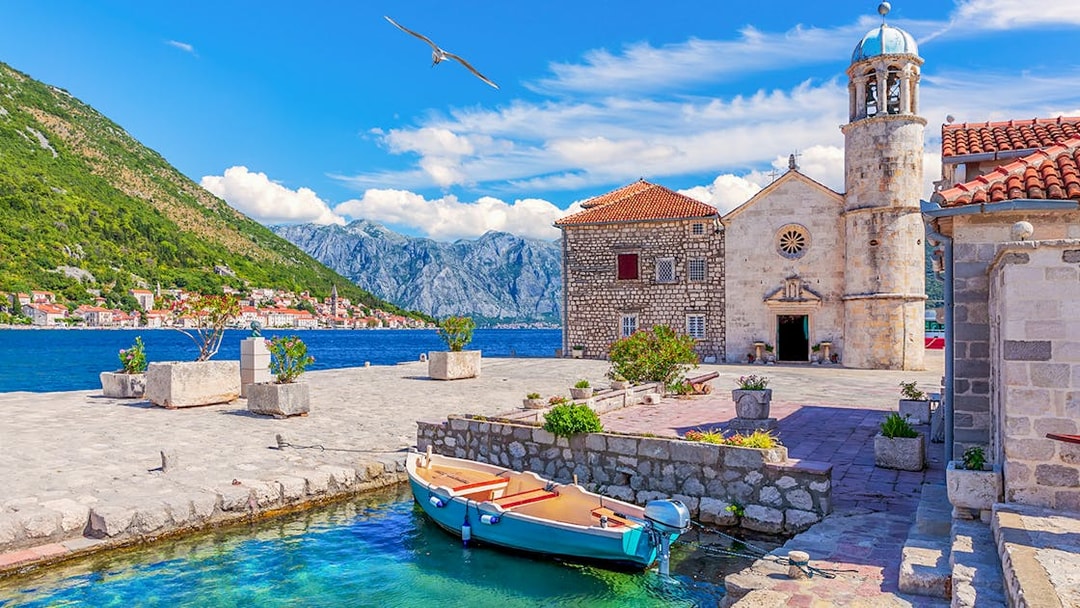 Church of Our Lady of the Rocks with boat in Bay of Kotor, Montenegro.