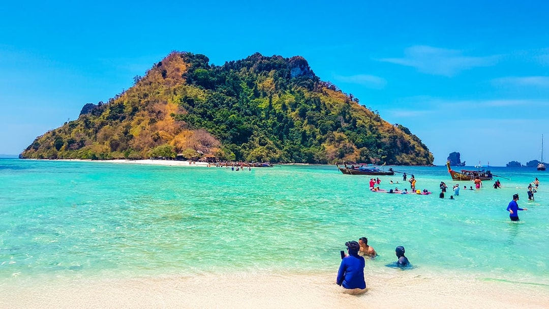 Tourists enjoying the clear waters and sandy beach of Thale Waek Island, Krabi.