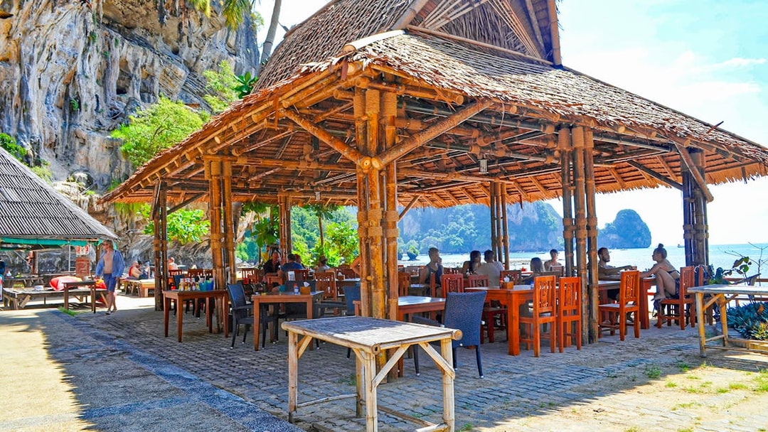 Bamboo restaurant by the beach at Tonsai Bay with diners enjoying the view.