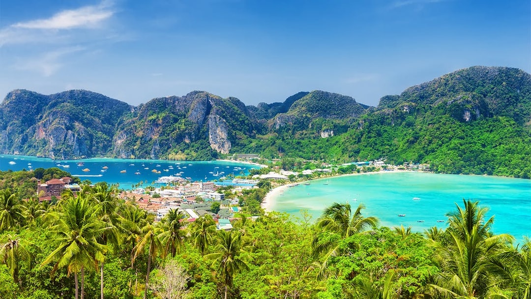 Phi Phi Island view with turquoise waters and lush hills, Phuket to Phi Phi Island tours.