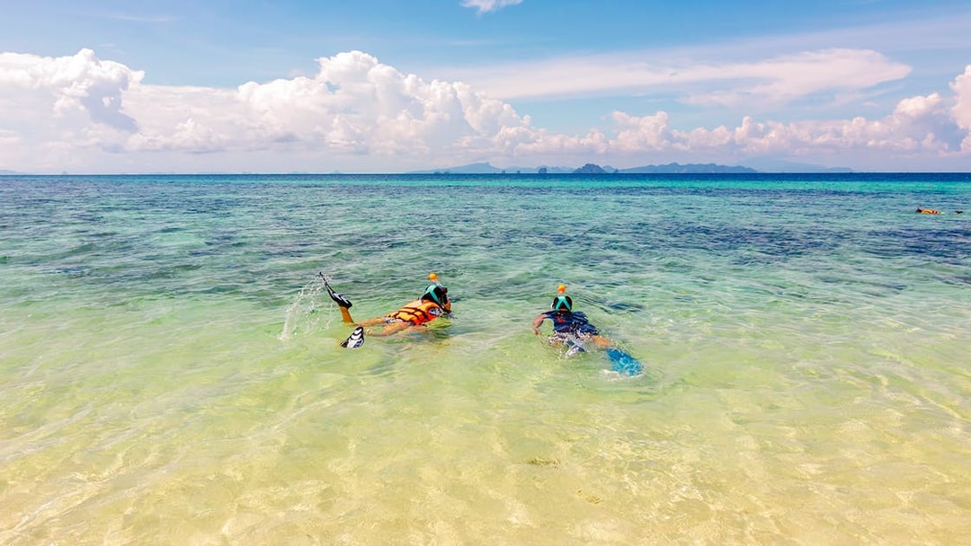 Snorkelers exploring clear waters near Bamboo Island, Thailand.