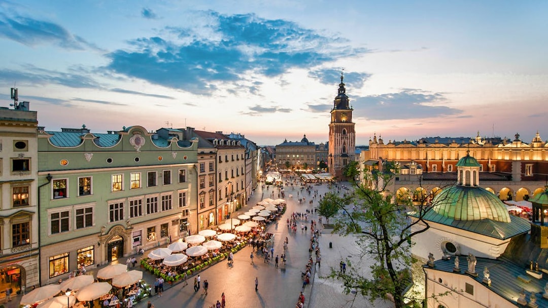 Krakow's Main Square at sunset with St. Mary's Basilica and Cloth Hall.