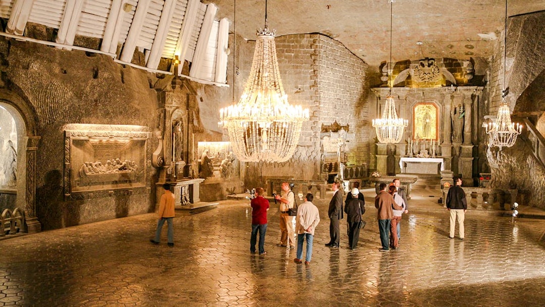 Visitors exploring the ornate chapel inside Wieliczka Salt Mine on a guided tour.