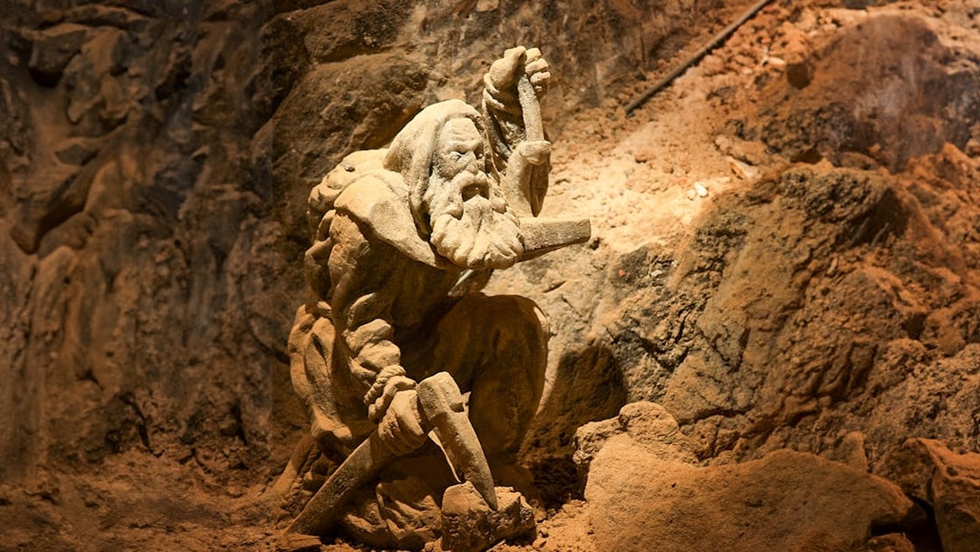 Miner statue in Bochnia Salt Mine, Poland, depicting historical salt mining activities.