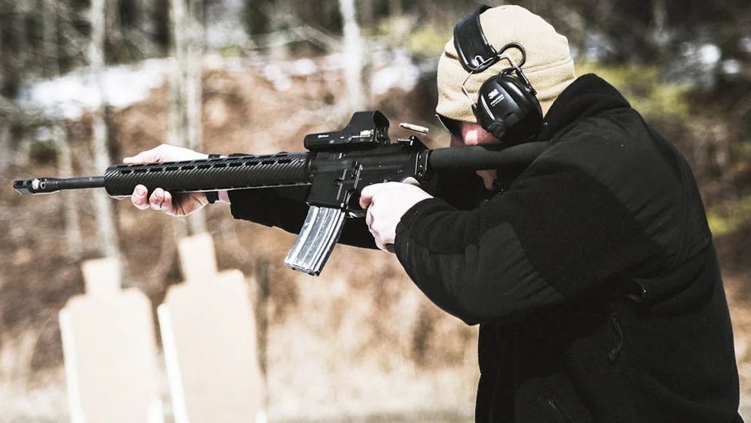 Person aiming rifle at targets at a shooting range in Krakow.