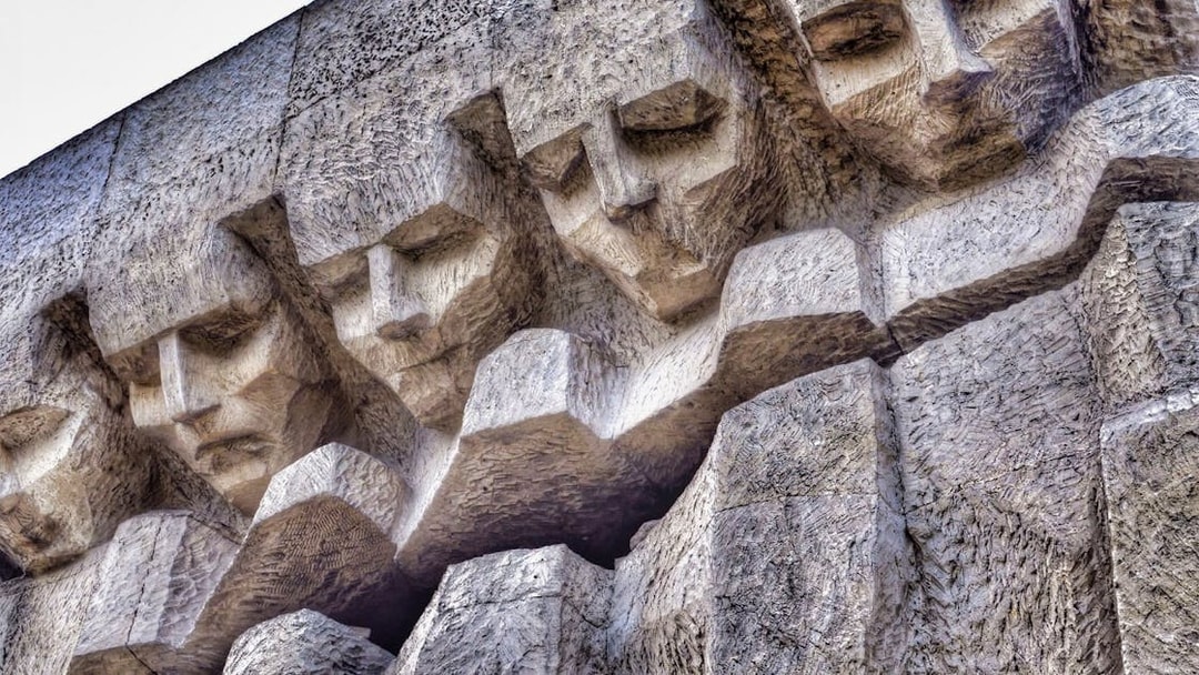 Stone relief of faces at Plaszow Concentration Camp memorial, Krakow.