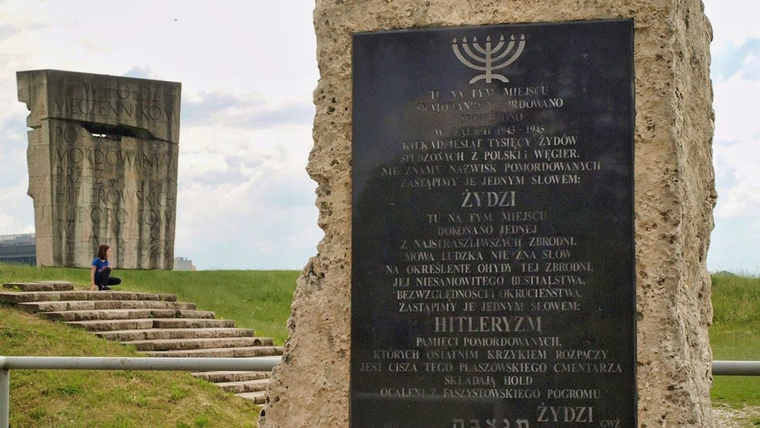Memorial at Plaszow Concentration Camp site with commemorative plaques and stone structures.