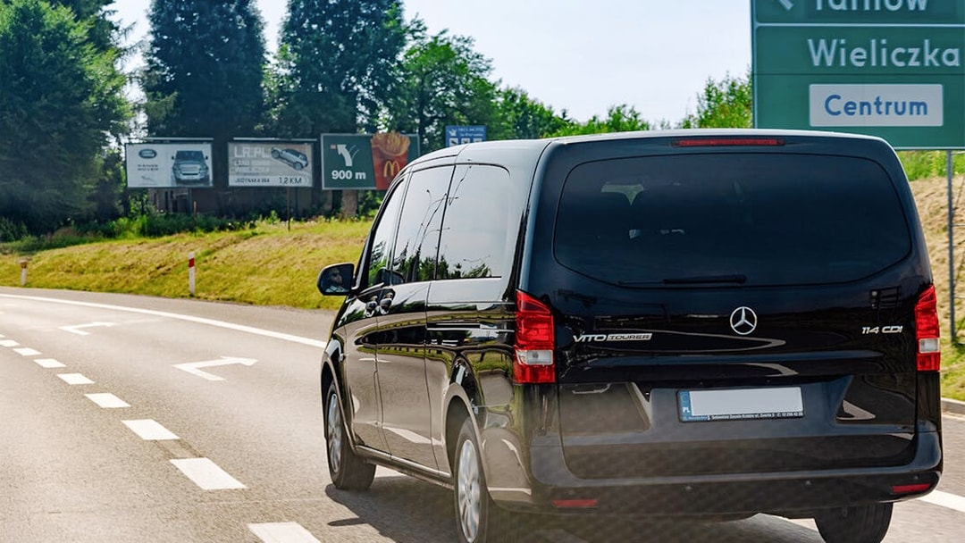Van traveling on road towards Wieliczka Salt Mine, Poland.