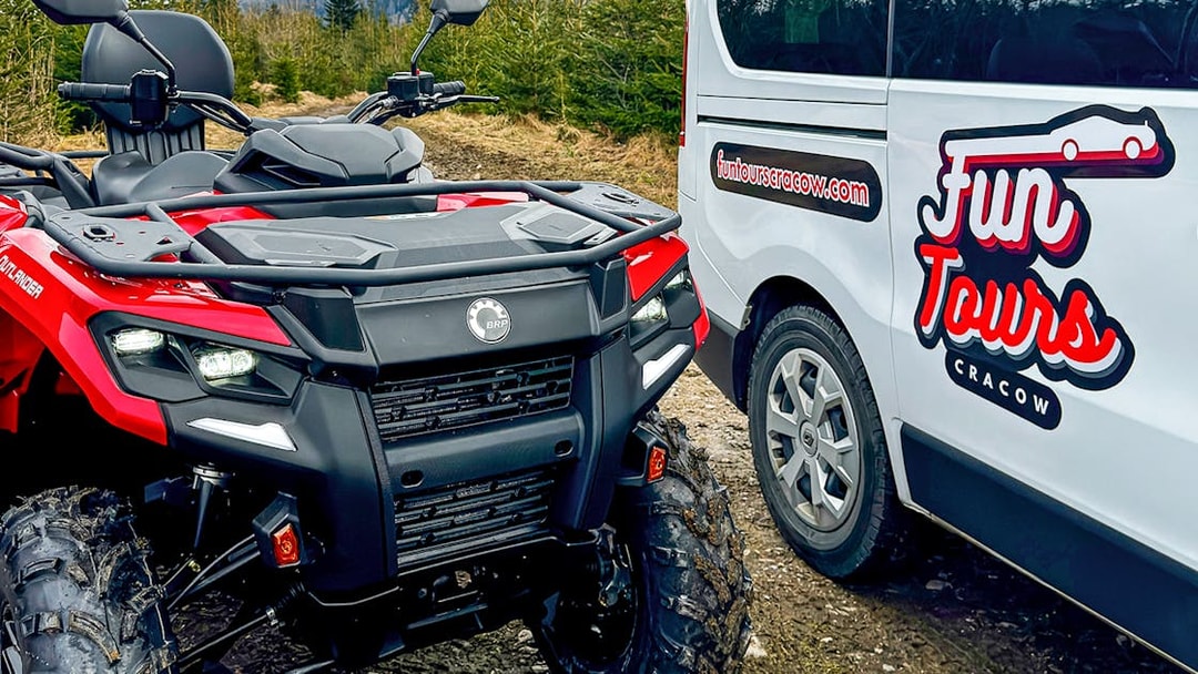 Quad bike and tour van in Zakopane forest setting.