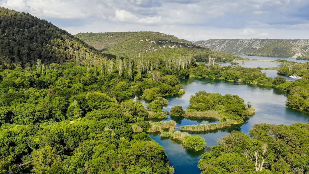Aerial view of Krka River winding through lush greenery in Croatia.