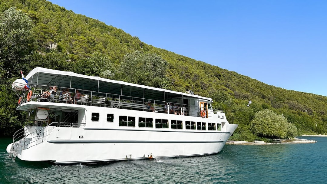 Boat with guests cruising through Krka National Park, Croatia.