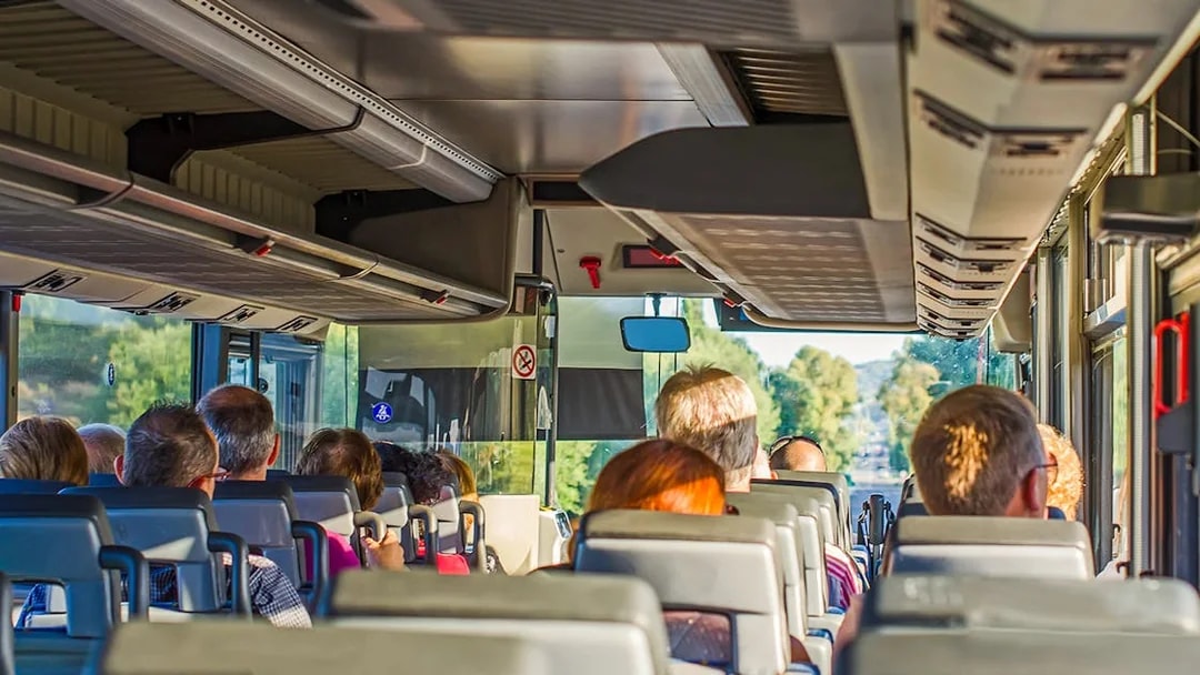 Bus interior with passengers traveling to Krka National Park.