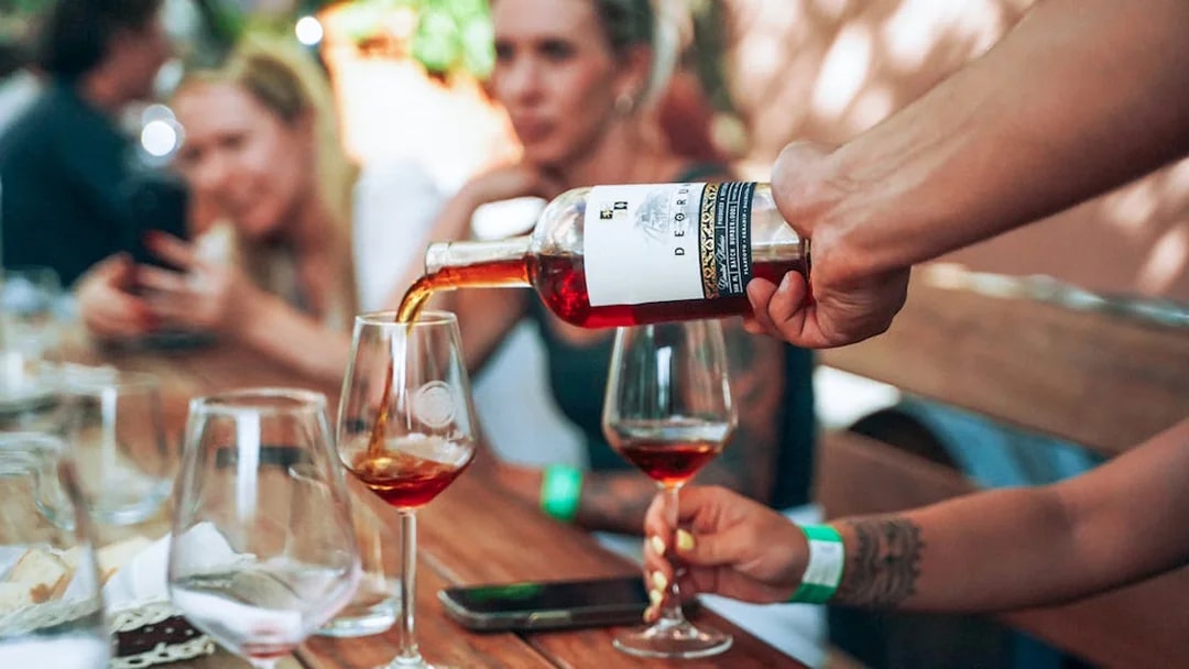 Wine being poured into glasses during Krka National Park tour.