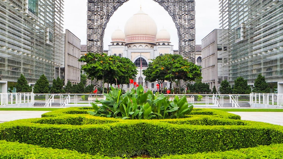 Kuala Lumpur architecture with lush gardens on a guided tour.