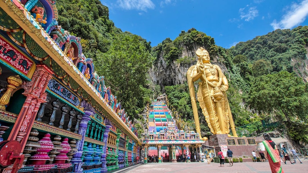 Murugan statue and colorful temple entrance at Batu Caves, Kuala Lumpur.
