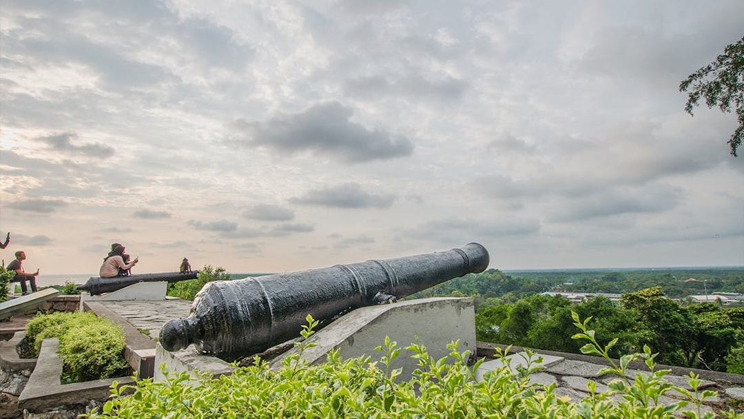 Cannon overlooking lush landscape at Malawati Hill near Batu Caves, Kuala Lumpur.