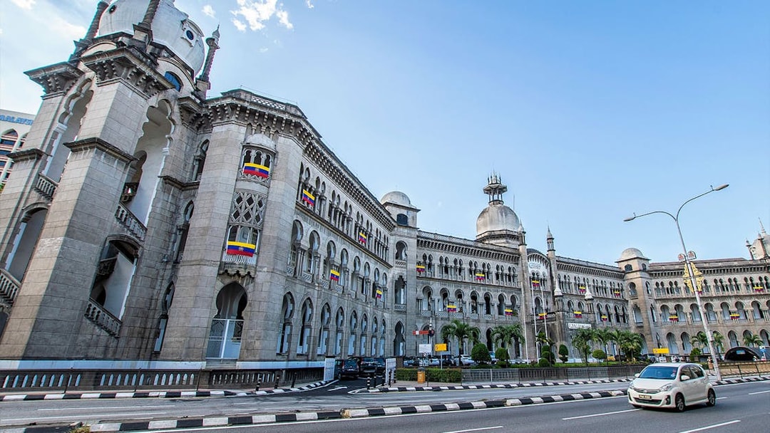 Kuala Lumpur Railway Station with Moorish architecture on a sunny day.
