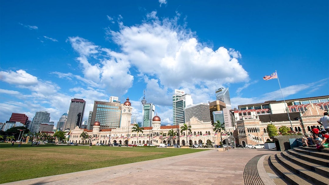 Merdeka Square in Kuala Lumpur with Sultan Abdul Samad Building and city skyline.