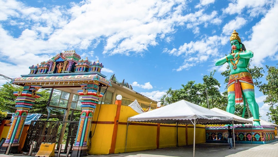 Colorful entrance and large statue at Batu Caves, Malaysia, on a day tour.