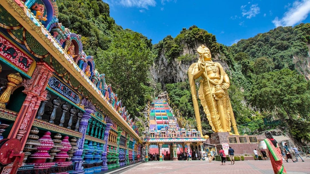 Colorful steps and large statue at Batu Caves, Malaysia, part of Colmar Tropicale day tour.