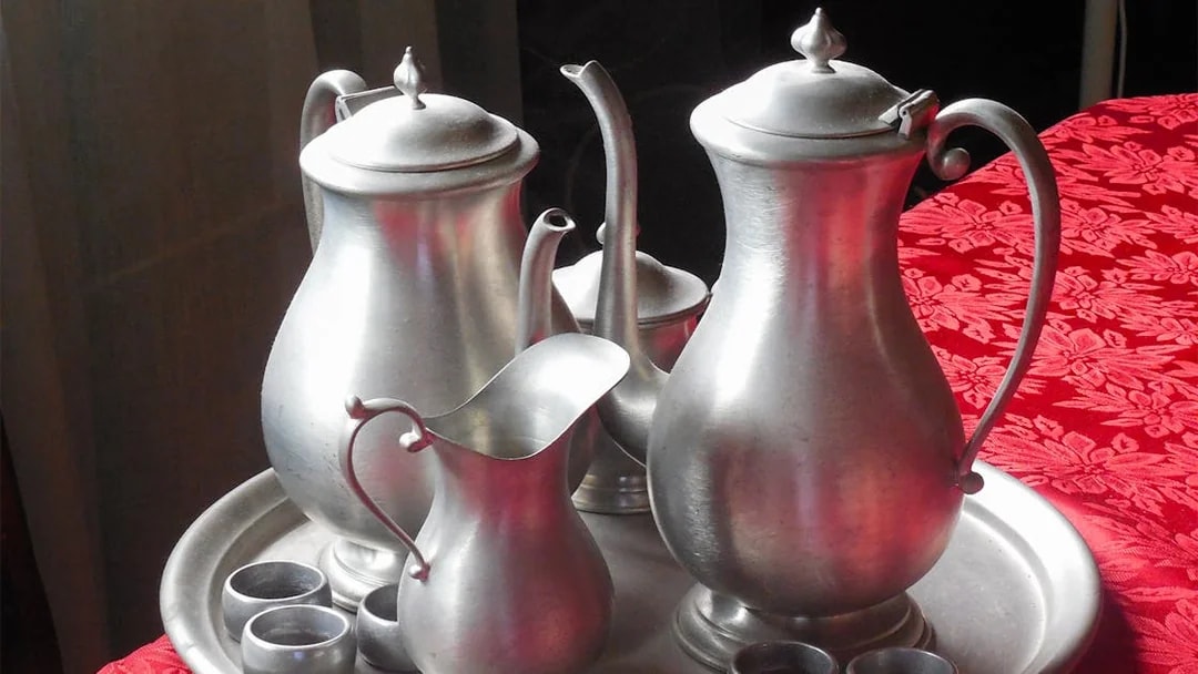 Silver tea set on a red tablecloth, part of a cultural experience on the Batu Caves tour from Kuala Lumpur.