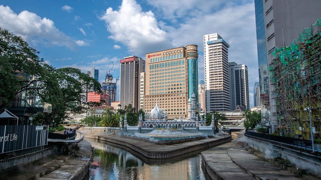 Kuala Lumpur skyline with Jamek Mosque by the river.