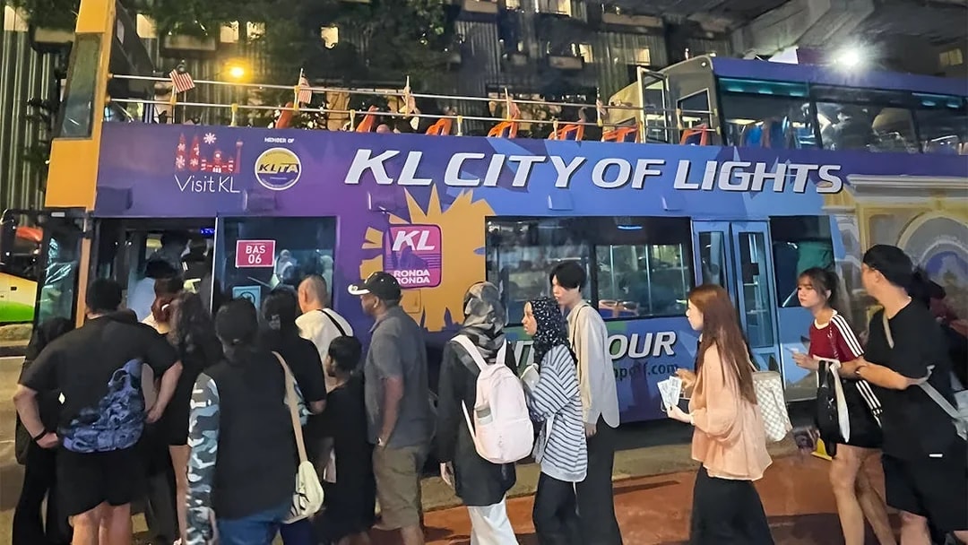 Kuala Lumpur night bus tour with people boarding the KL City of Lights double-decker.