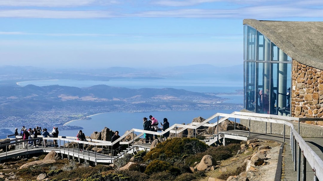 Visitors enjoying the view from kunanyi Mt Wellington lookout, Hobart, Tasmania.