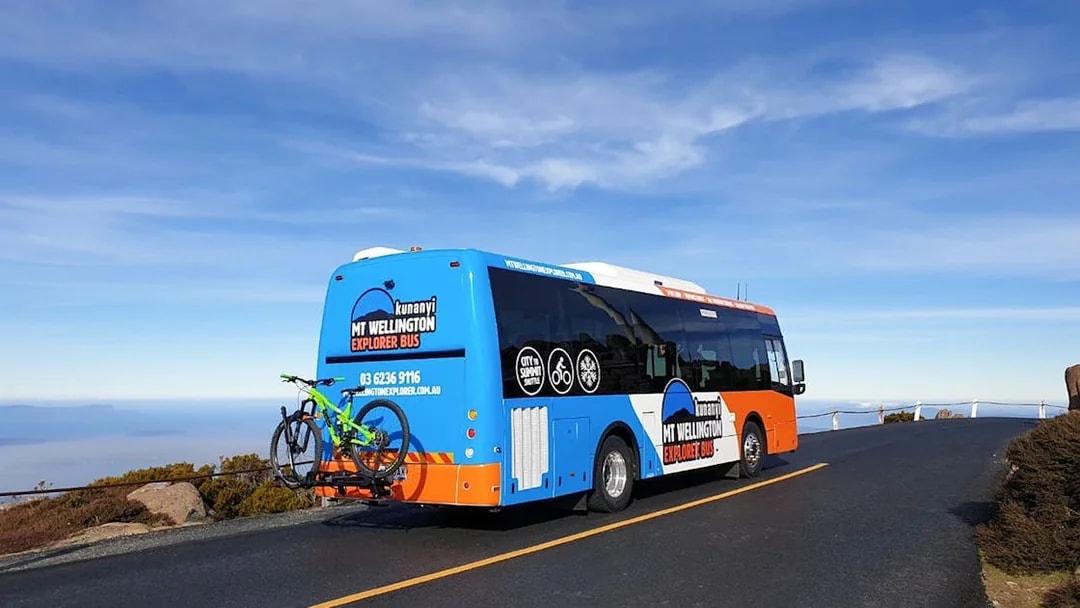 Kunanyi/Mt Wellington Explorer Bus on mountain road with bike rack.