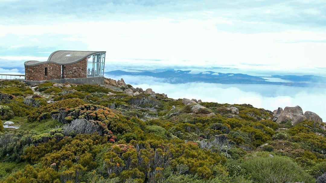 kunanyi Mt Wellington summit view with observation shelter and distant landscape.