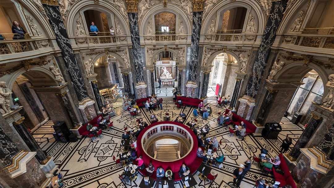 Kunsthistorisches Museum interior with ornate architecture and visitors in Vienna.