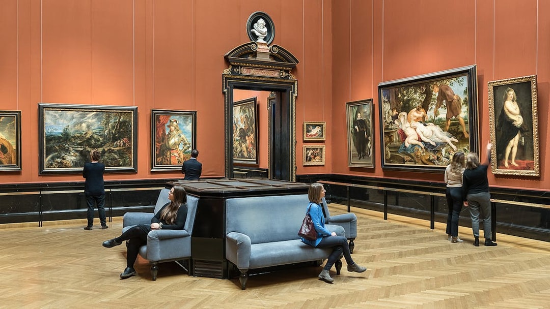 Visitors viewing paintings in a gallery at Kunsthistorisches Museum, Vienna.